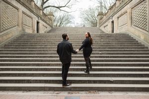 A sequence of photos showing a couple walking up grand stone steps in an outdoor setting.