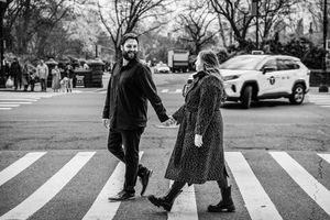 Couple walking across a crosswalk in winter attire.