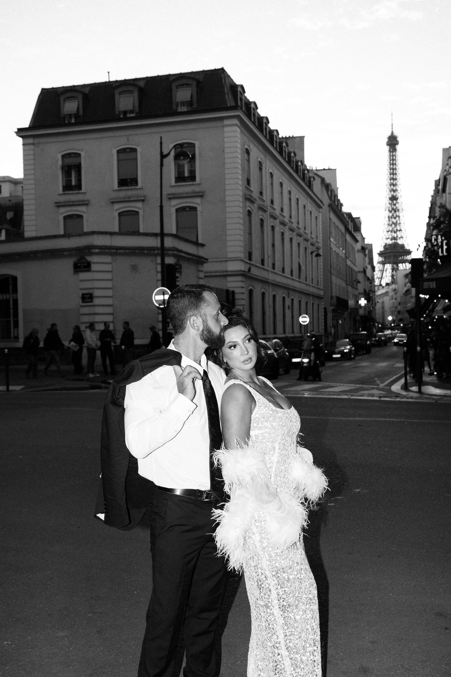 Romantic wedding couple embraces near the Eiffel Tower overlooking sunset. Best Paris Photographer