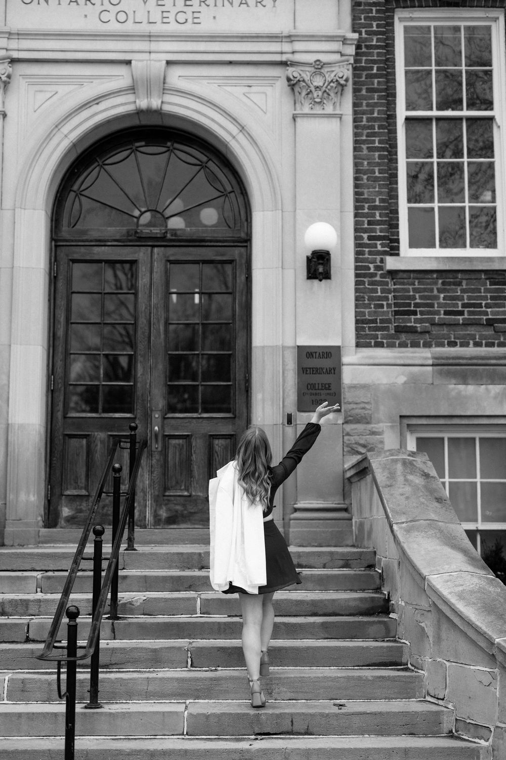 Historic entrance steps and doorways of the Ontario Veterinary College building with red brick facade and arched details.