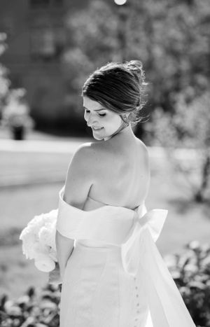 Elegant bridal portrait in soft black and white tones with natural lighting.