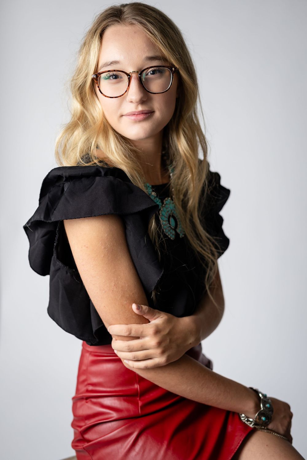 High school senior girl with glasses during a studio senior session in Mountain Home, Arkansas