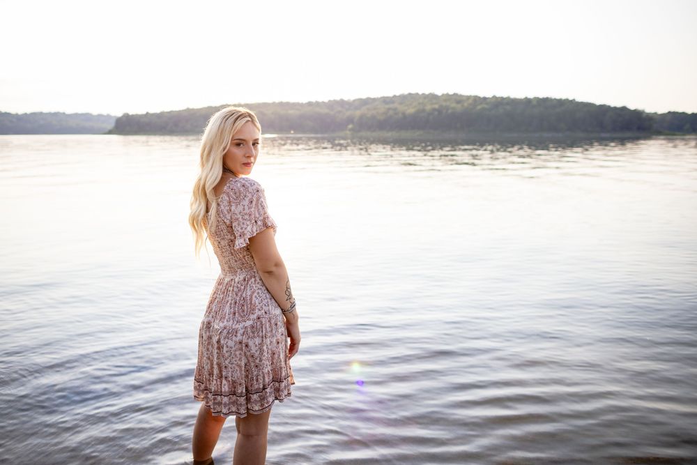 High school senior girl by the water during a senior session at Norfork Lake in Henderson, Arkansas