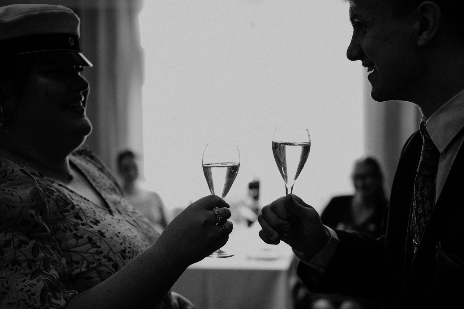 Group of people toasting with champagne glasses in a celebratory moment at a gathering.