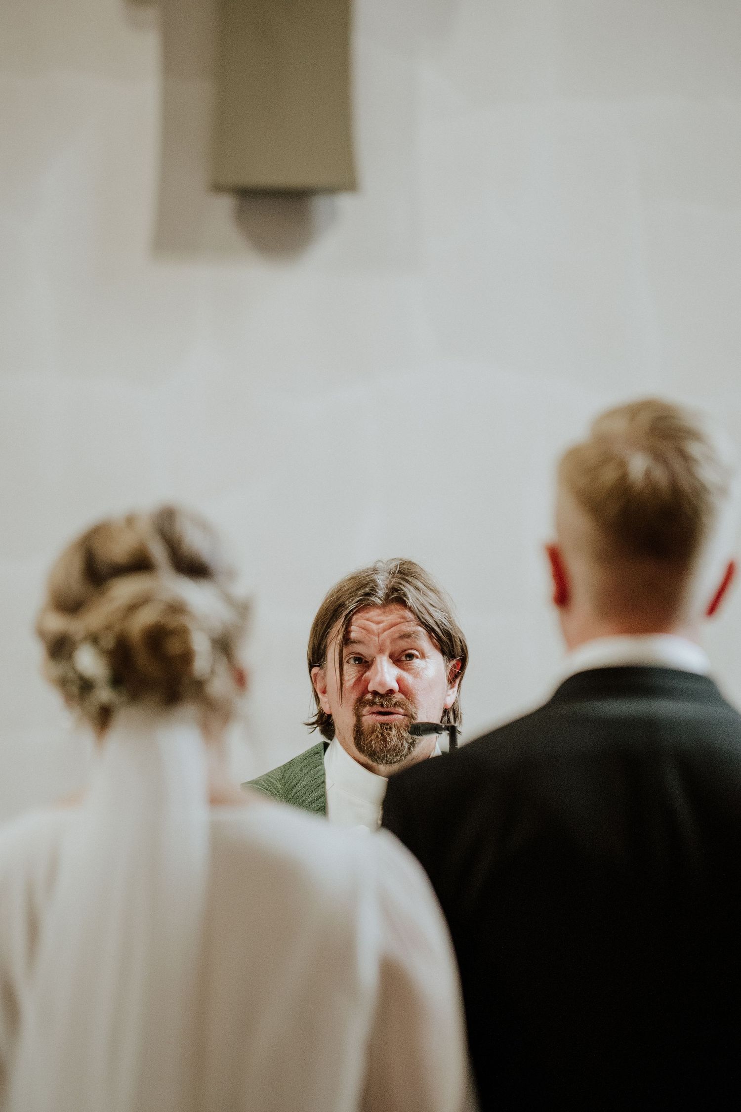 Emotional moment during indoor wedding ceremony.