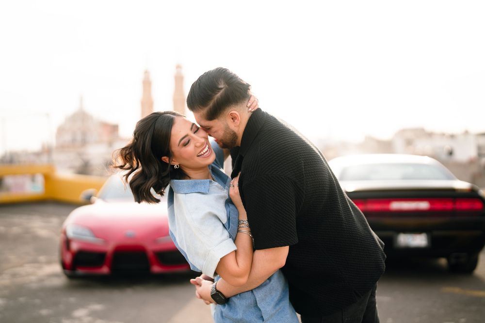 Couple in casual attire sharing tender moments during an outdoor photoshoot.