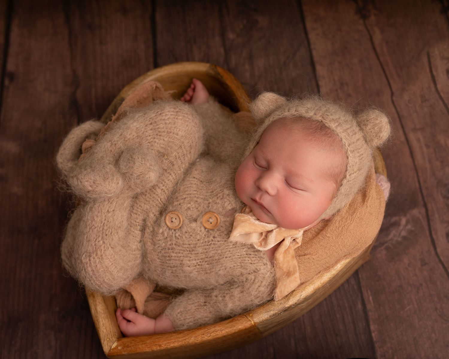 baby boy in brown bear costume in heart prop photographed by Bcapture photography in Swansea