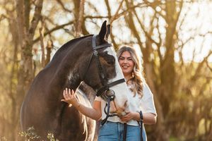 Beautiful horse photoshoot in a wooded area during sunset with warm golden lighting.