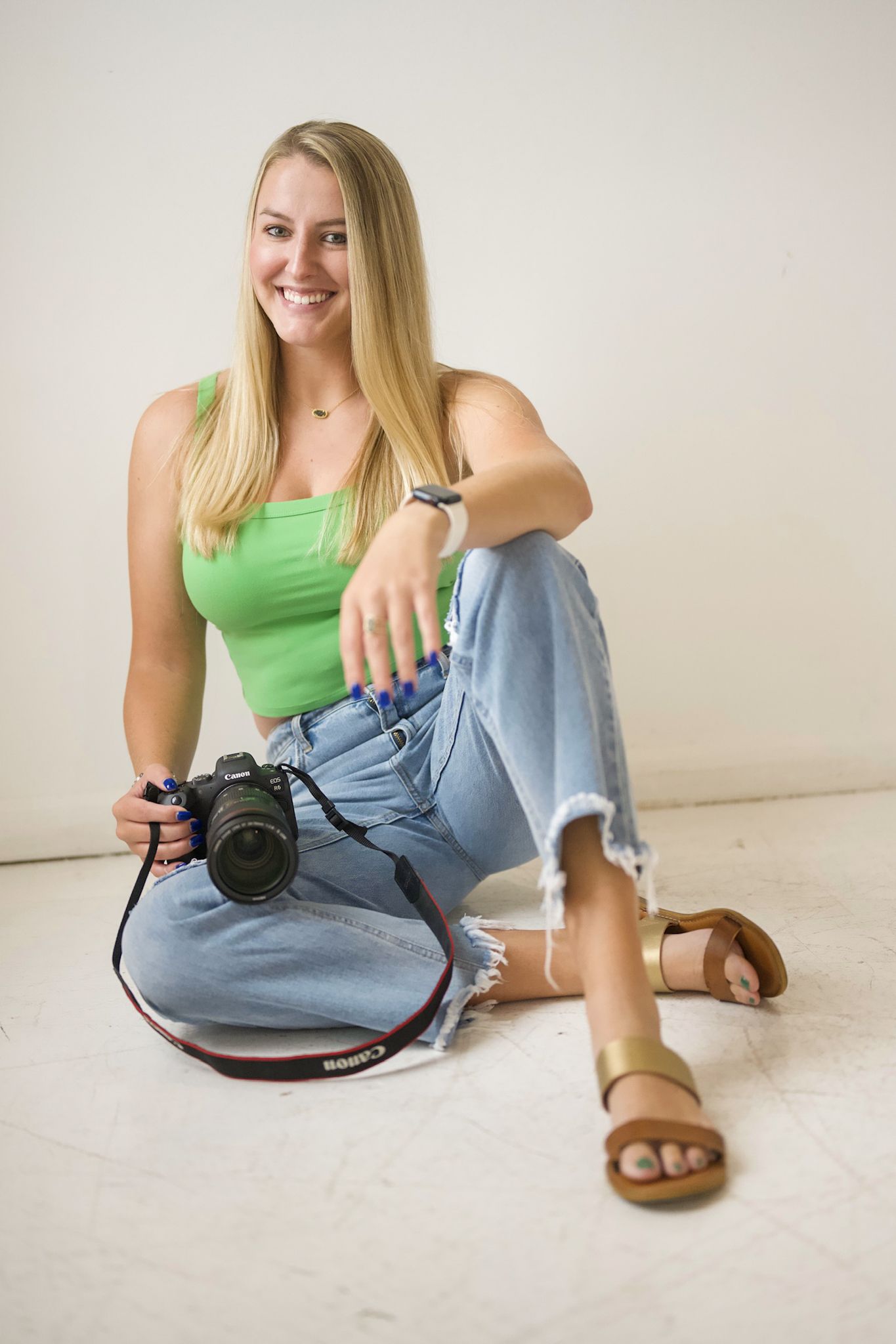 Portrait session showing casual poses with camera on white floor.