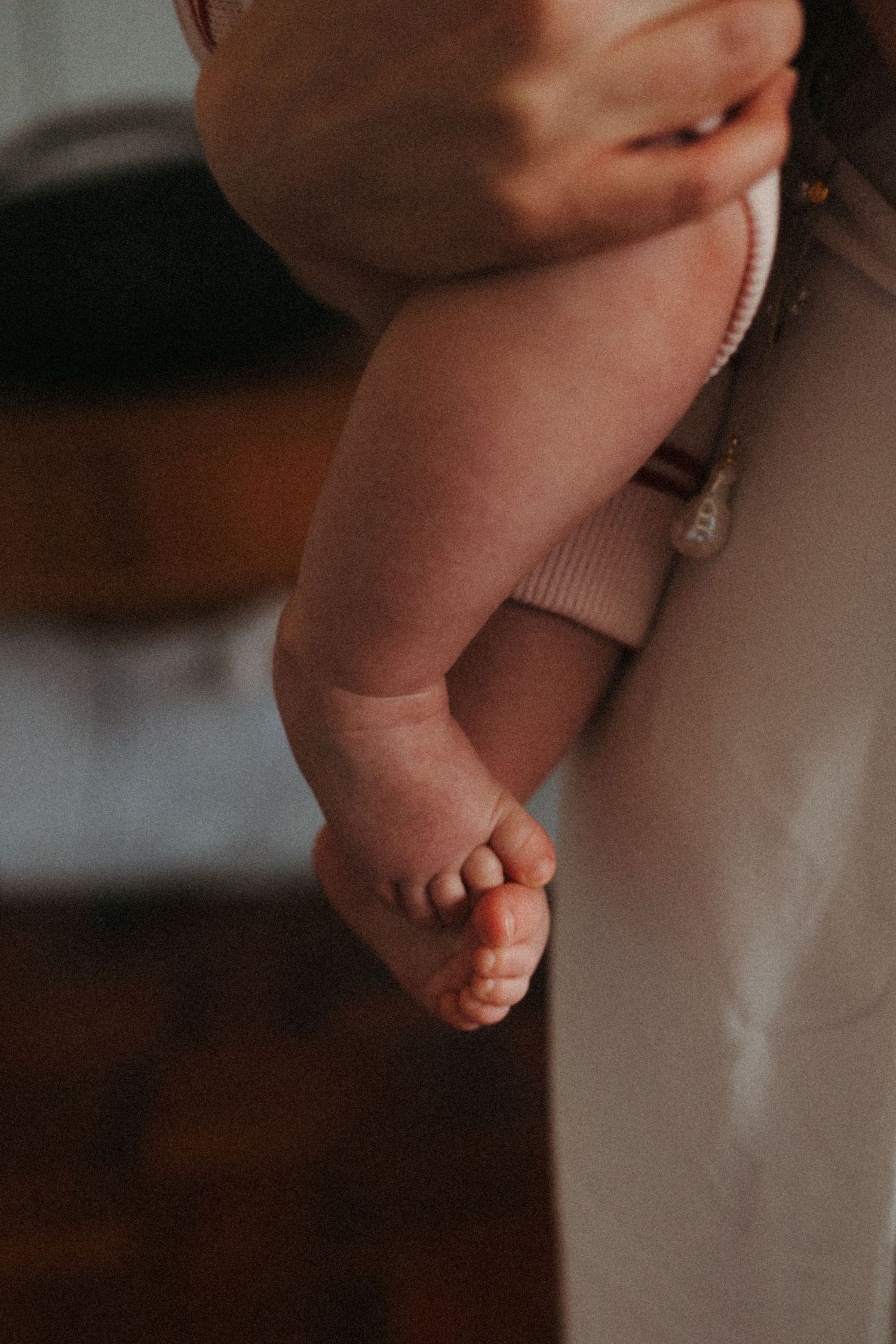Close-up detail shot of tiny baby feet against soft background.