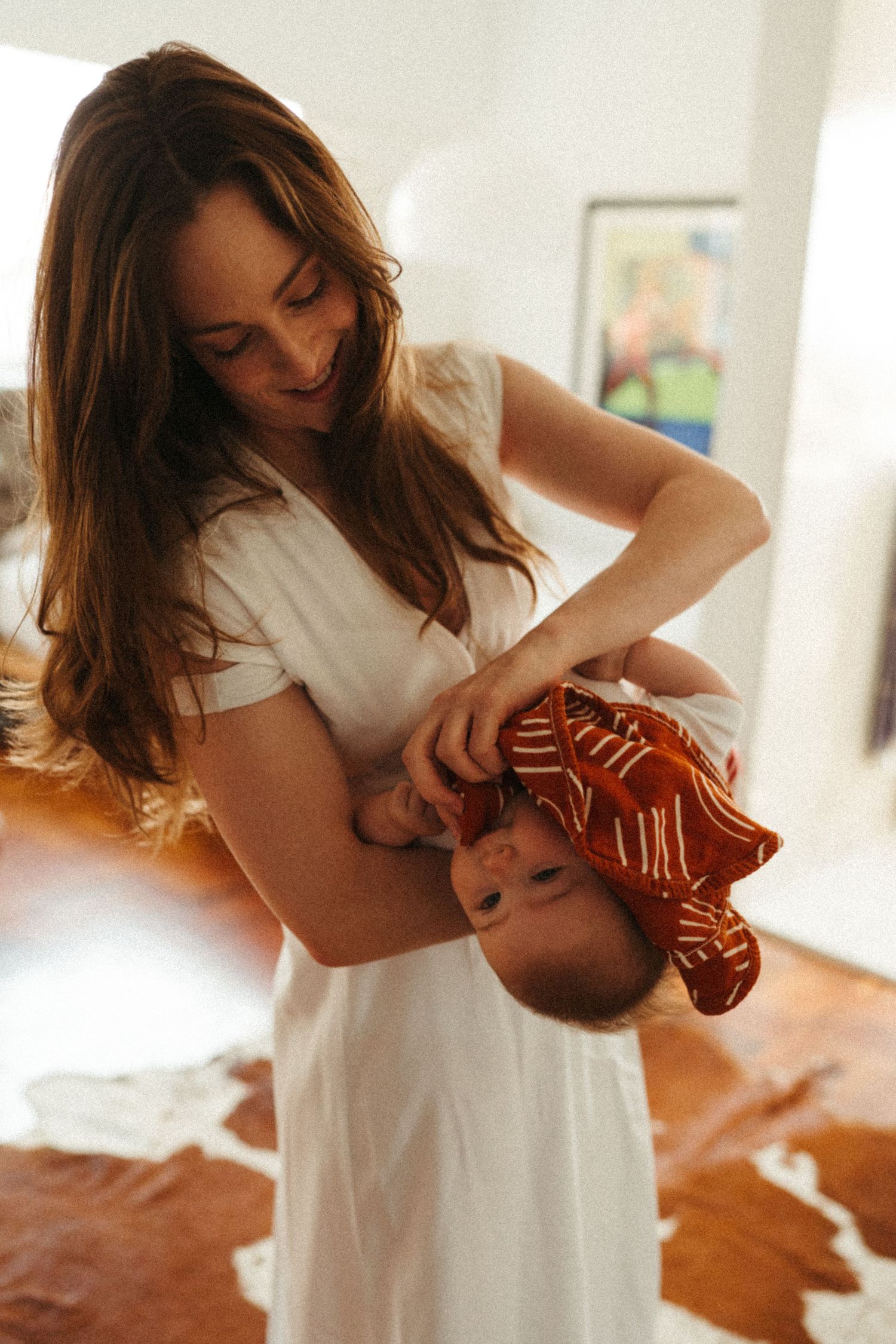 Tender family interaction captured in warm indoor lighting.