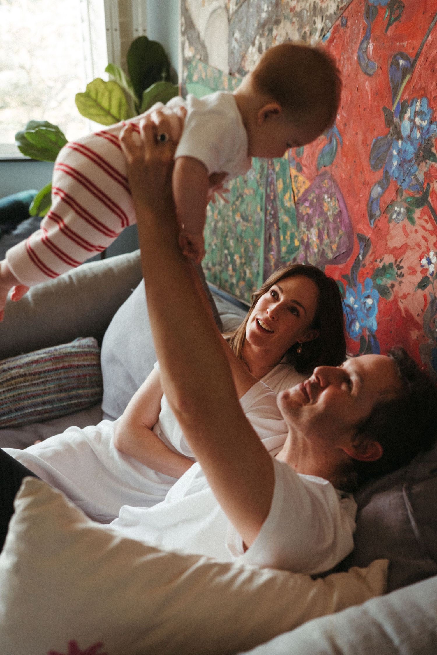 Candid sequence showing joyful playtime moments against a colorful painted wall.
