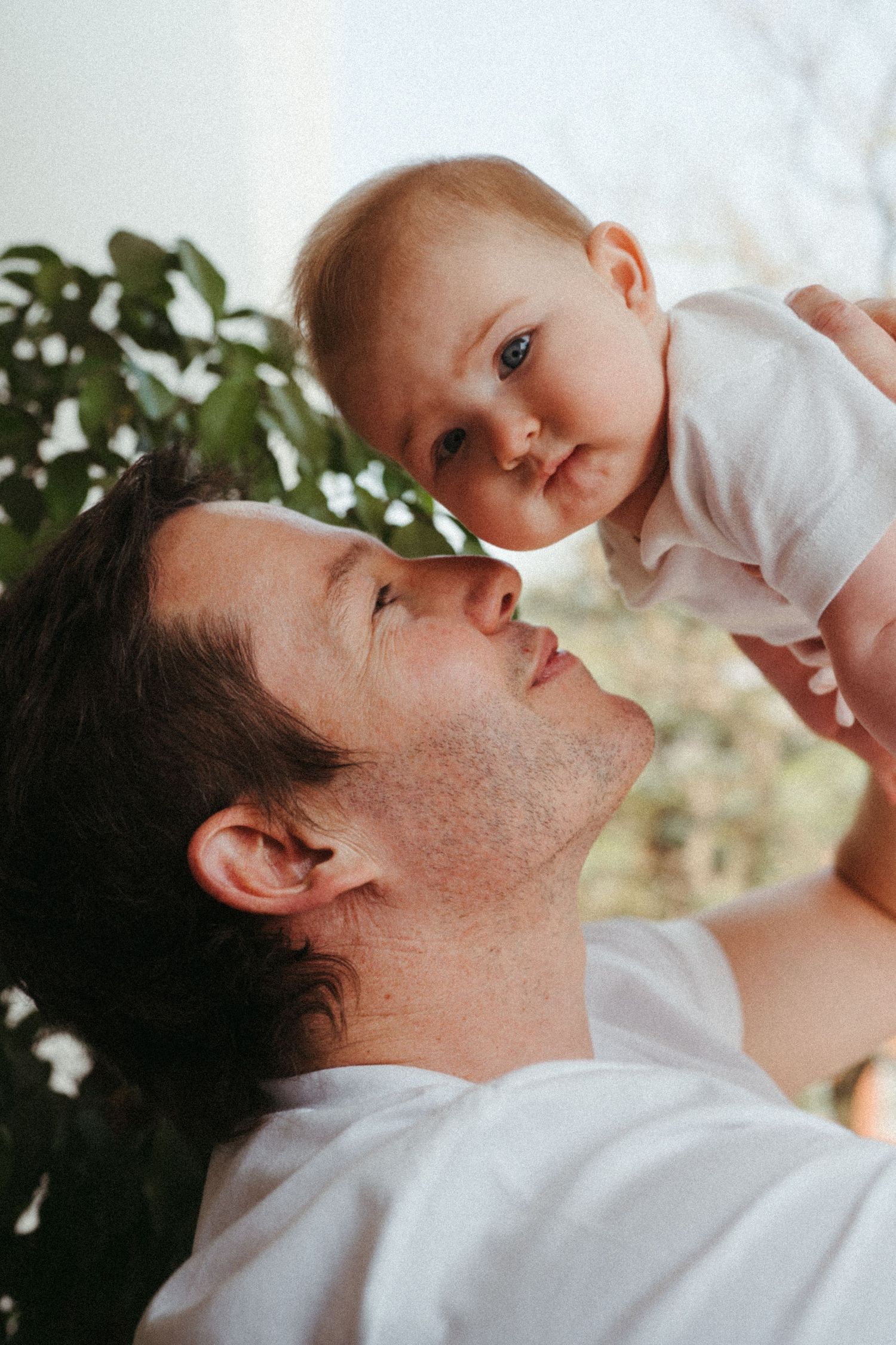 Intimate close-up sequence showing gentle parent-child interaction.