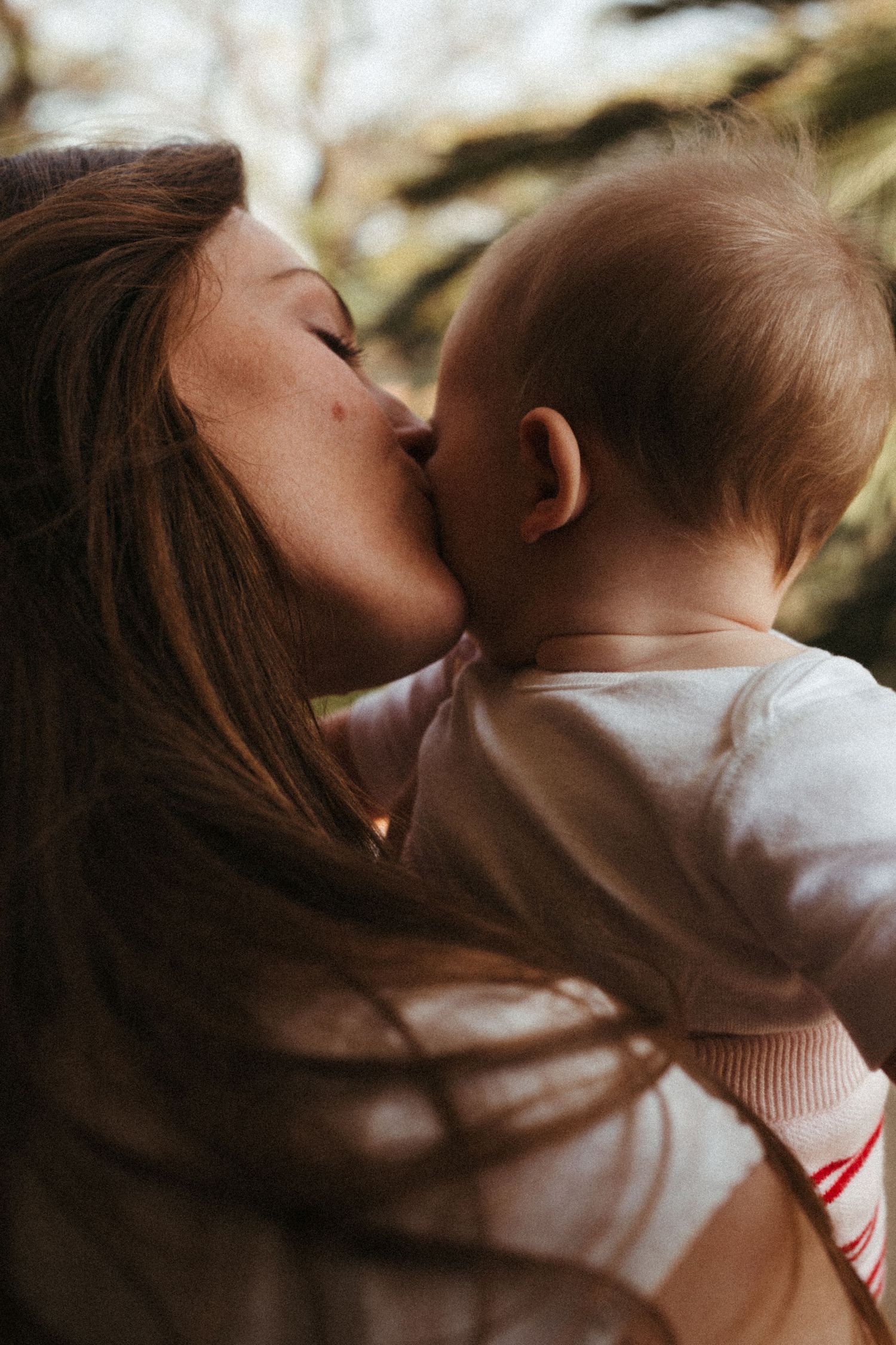 Intimate sequence showing gentle kisses and embraces in warm lighting.