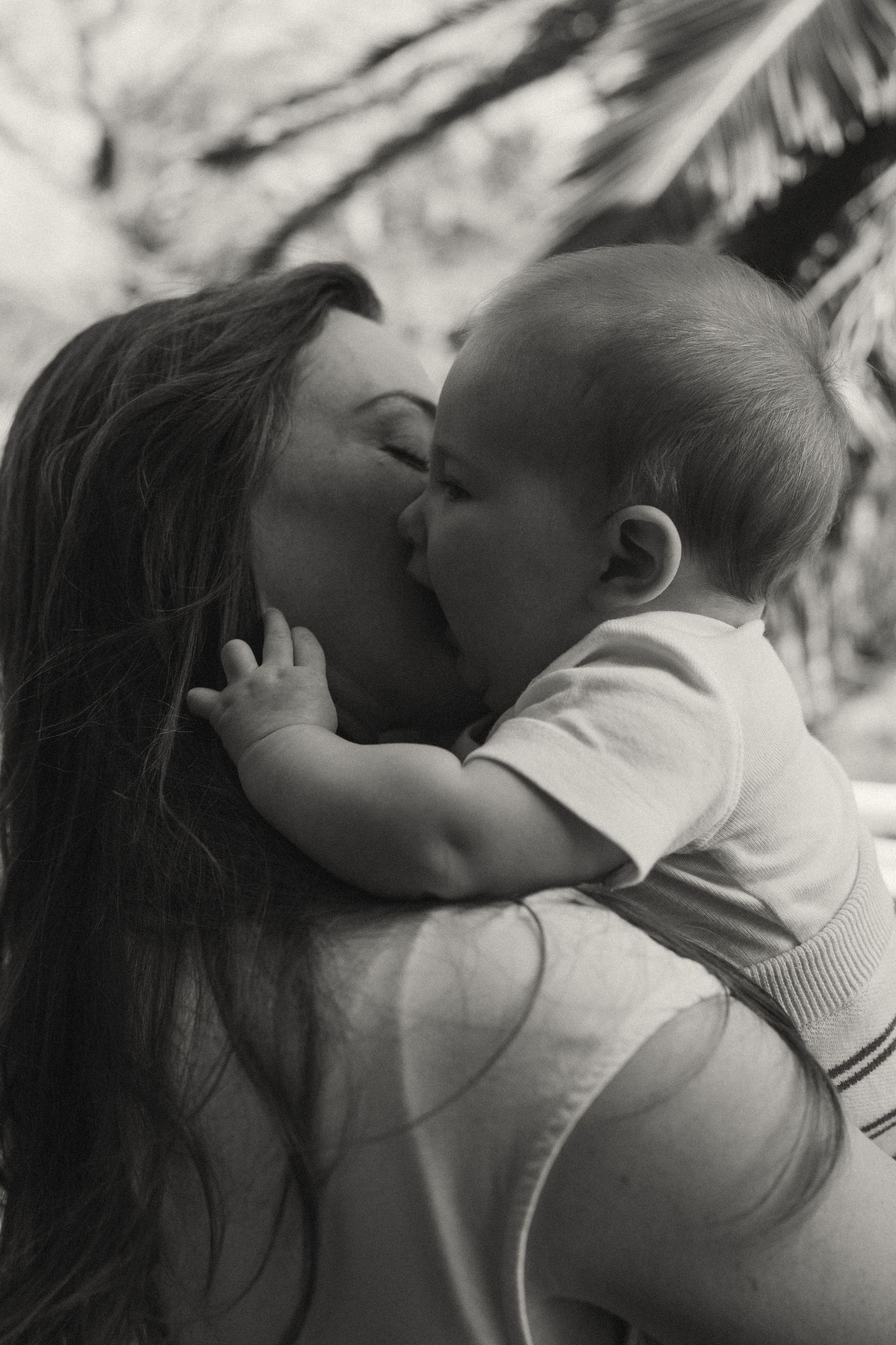 Black and white intimate portraits of parent and infant bonding.