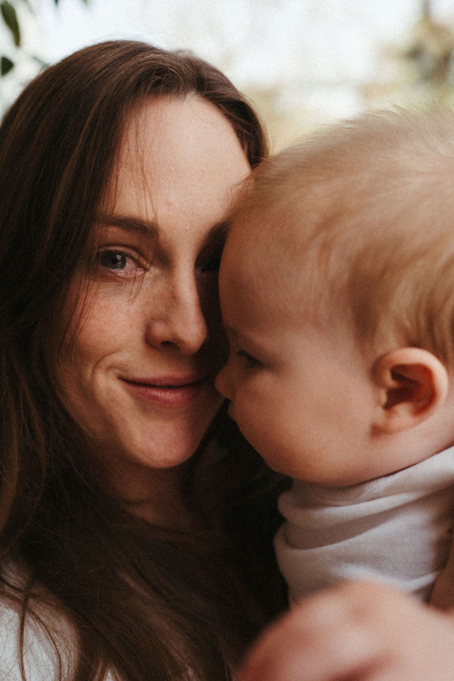 Intimate sequence of parent and baby sharing affectionate moments.