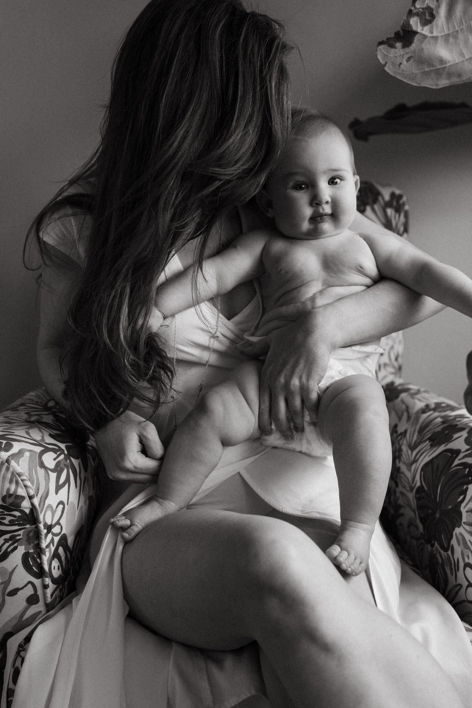 Artistic black and white photos of parent cradling baby.