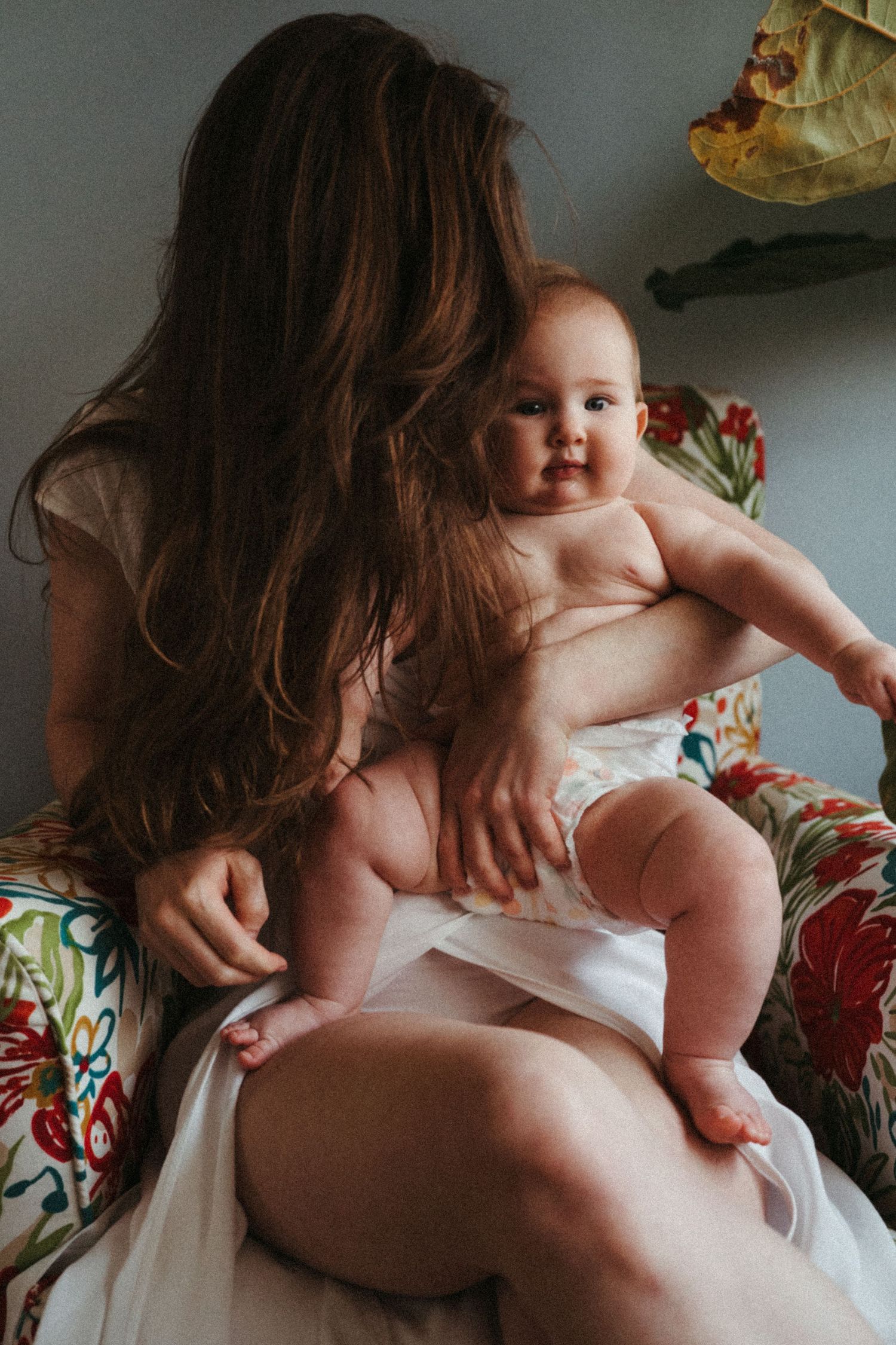 Intimate moments between parent and baby in natural indoor lighting.