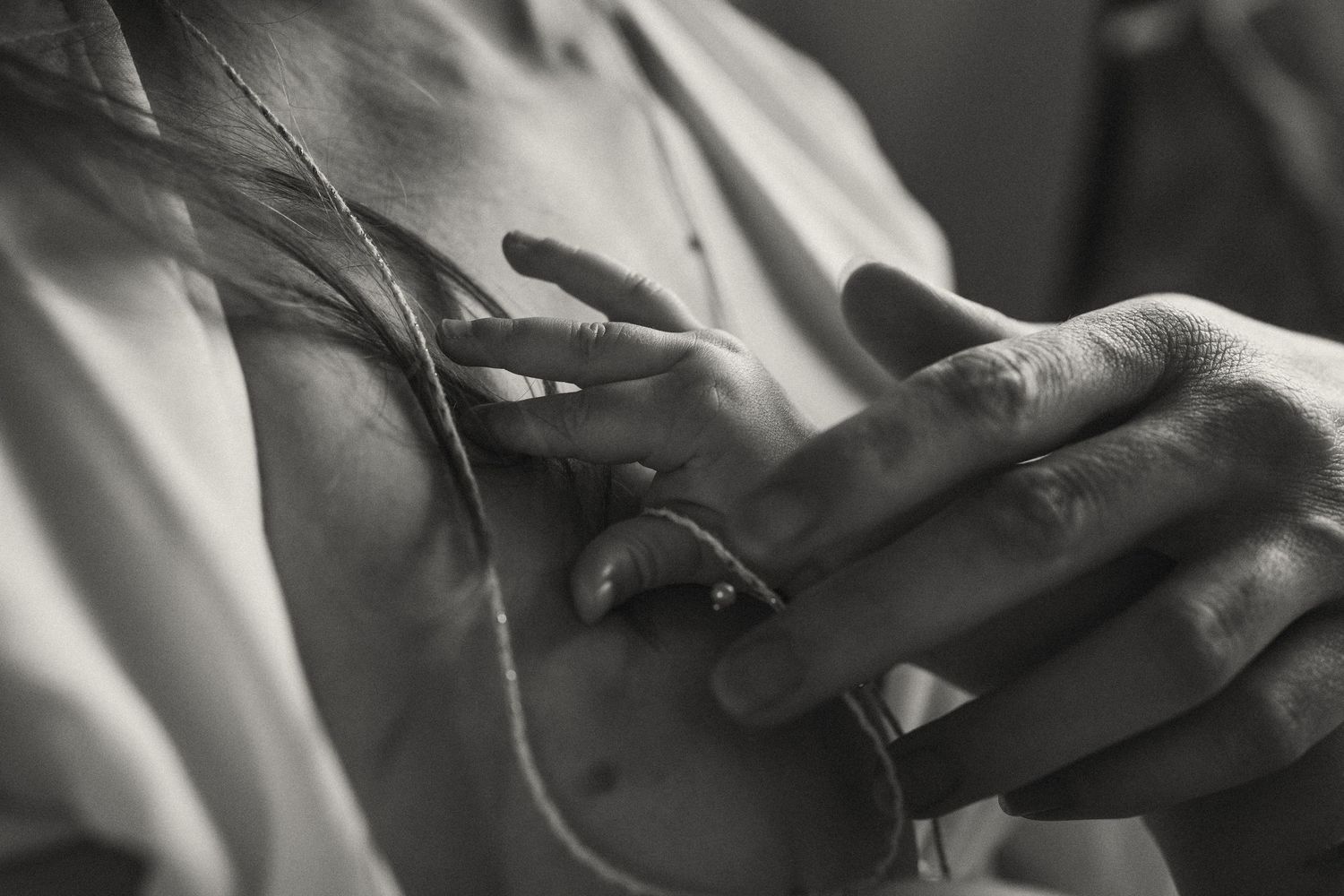Artistic black and white close-up showing gentle touch and connection.