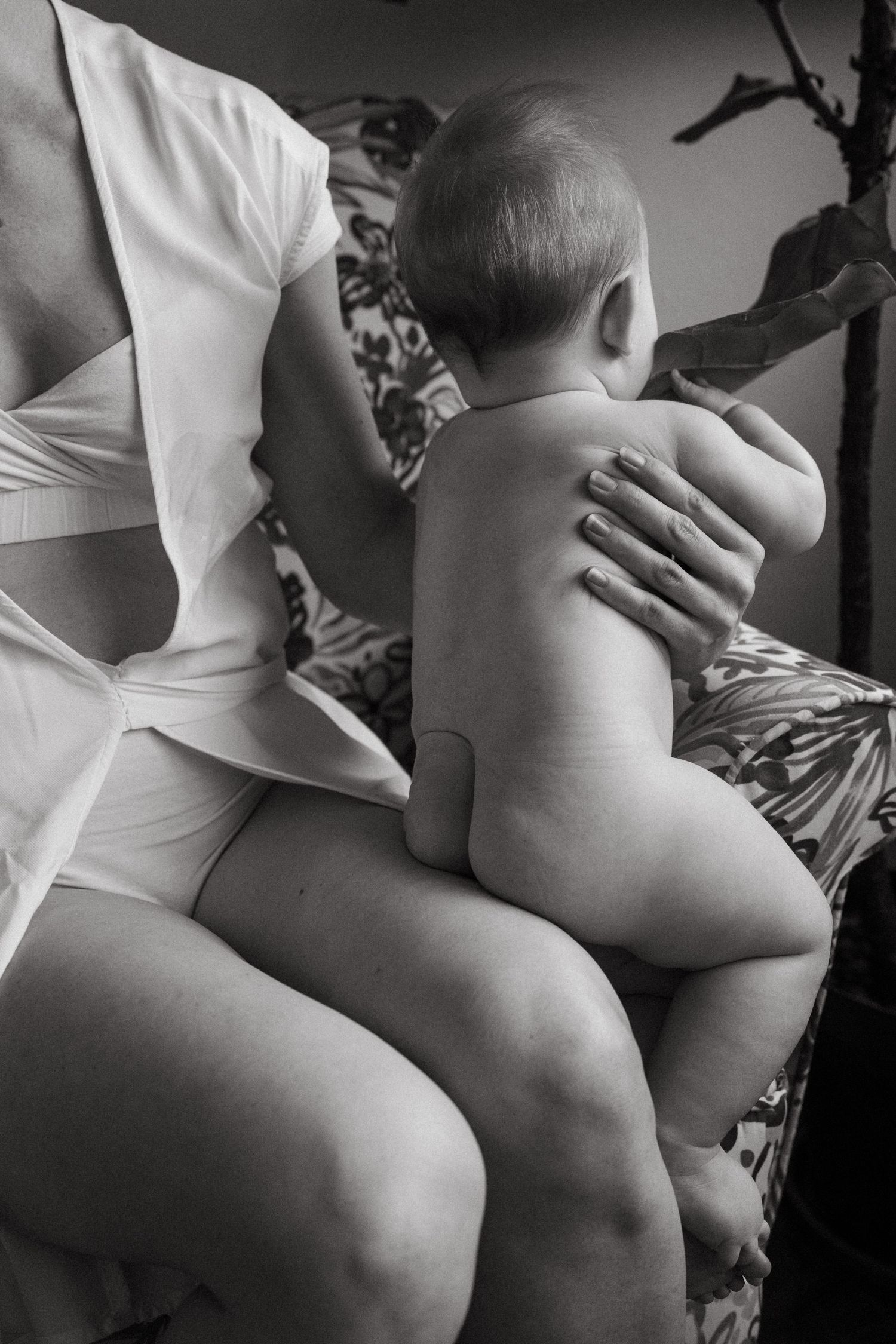 Black and white artistic study of infant forms and curves.