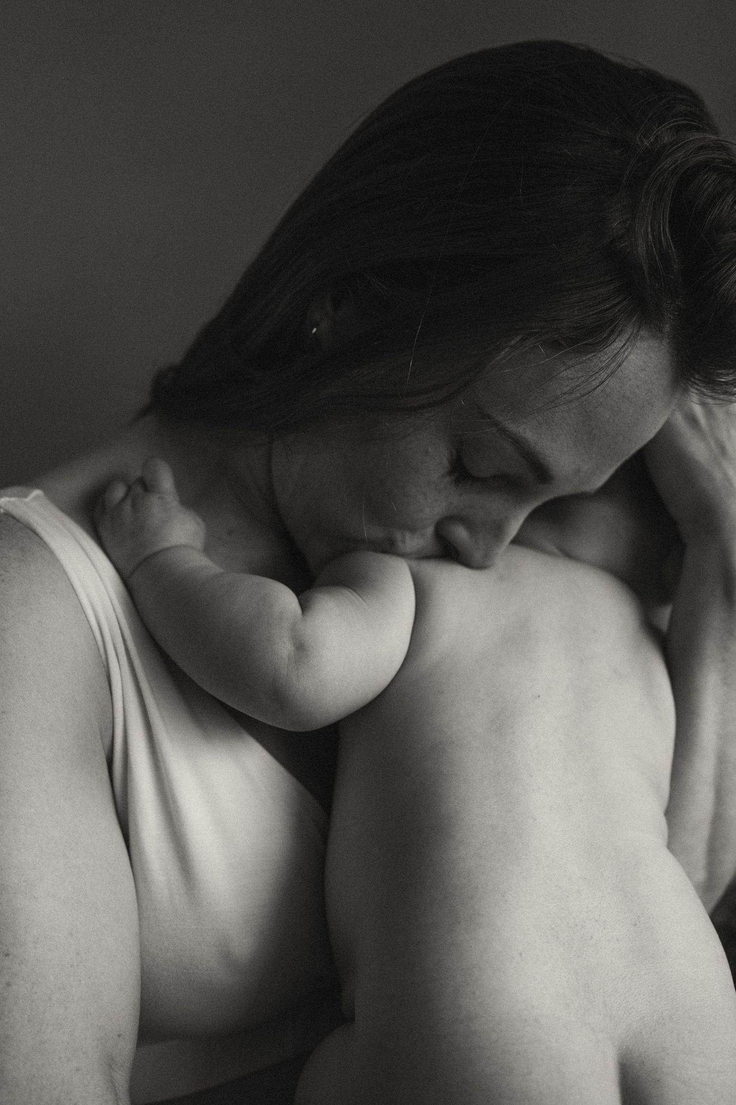 Intimate black and white portrait showing gentle embrace and connection.