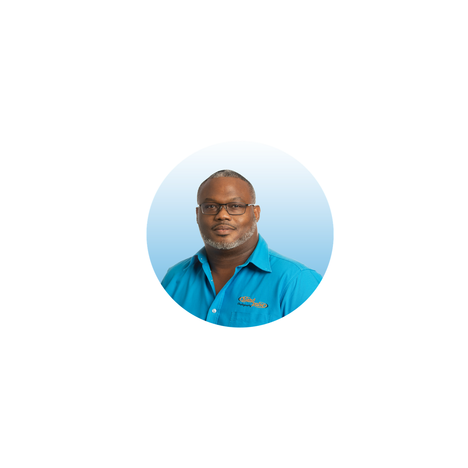 Professional headshot of a smiling man wearing glasses and a blue polo shirt on a light blue background.