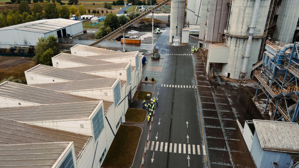 Aerial view of white industrial buildings.