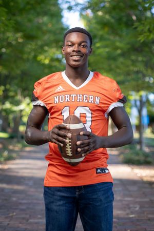 A series of photos showing someone in an orange Northern jersey holding a football in an outdoor park setting.