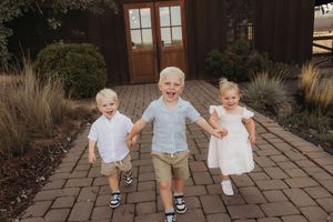 A series of candid outdoor photos showing toddlers walking and playing on a brick paved path in casual clothing.