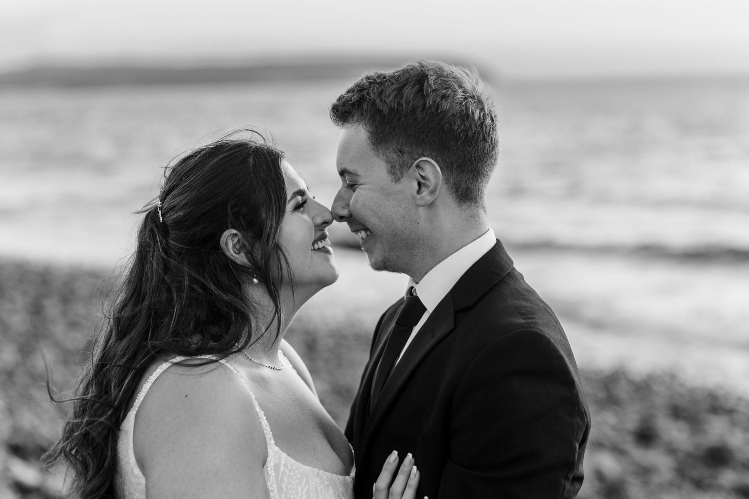 Intimate black and white wedding portraits captured against natural backdrop.