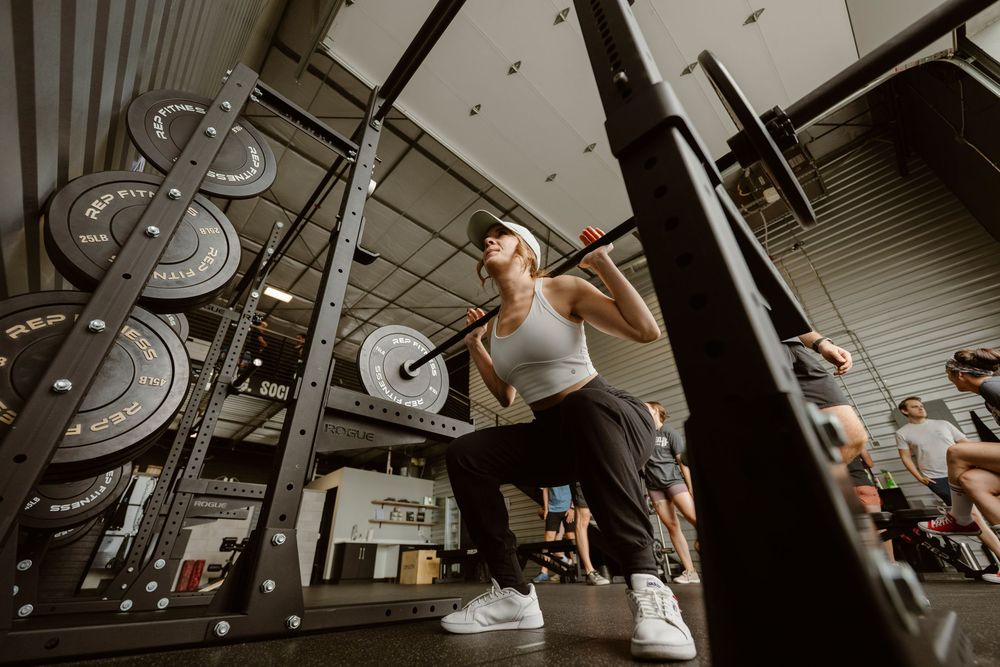 A series of connected images showing someone performing pull-ups on a bar in a gym setting.