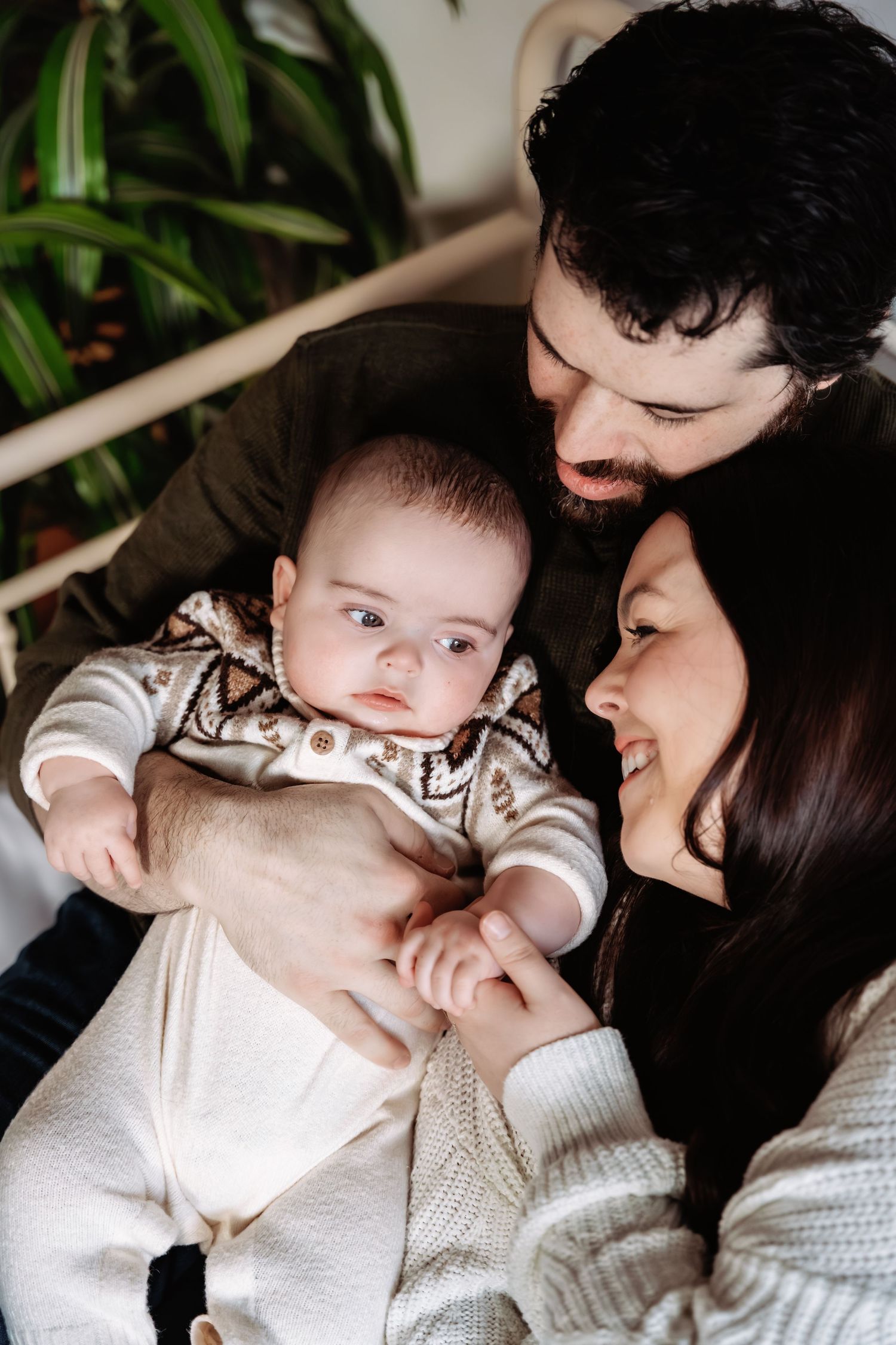 Intimate series of a parent and baby sharing affectionate moments on a white background.