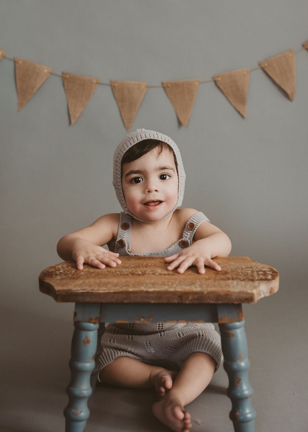 1 year old boy with knitted hat celebrating his birthday