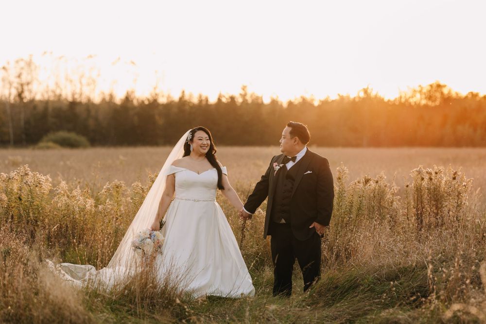 A romantic sunset wedding photo session in a field of wild grass.