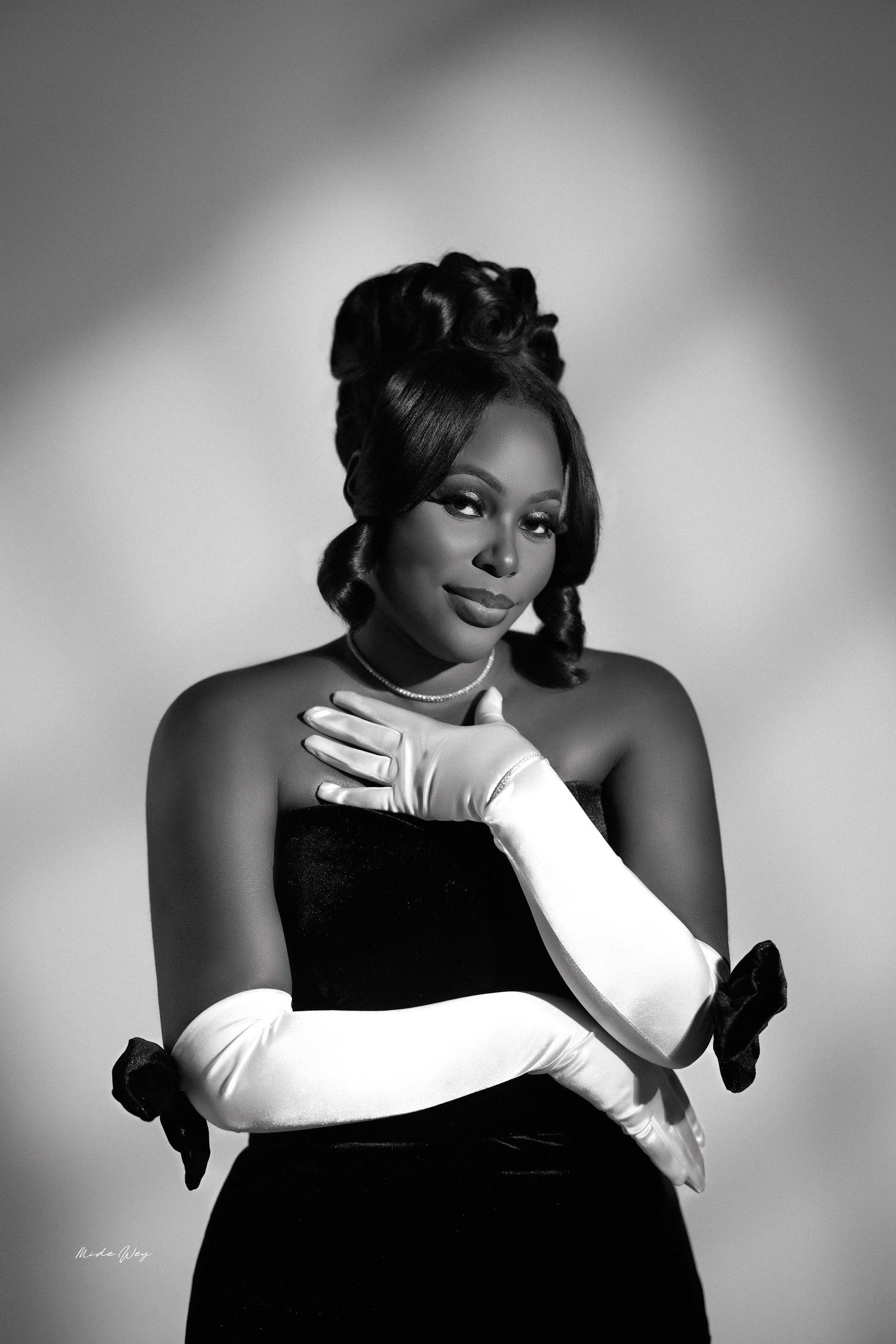 Artistic black and white portrait series showing elegant poses with white gloves against dark background.
