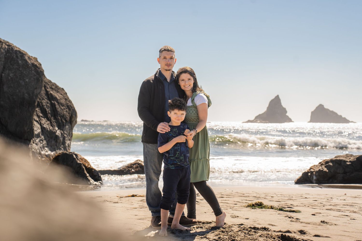 family of 3 portrait at the beach