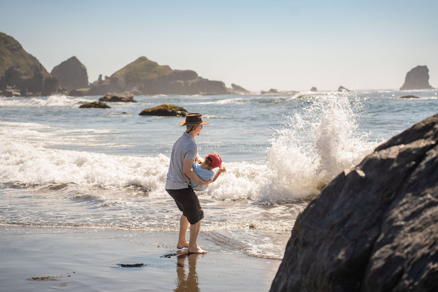 father and son playing at the beach