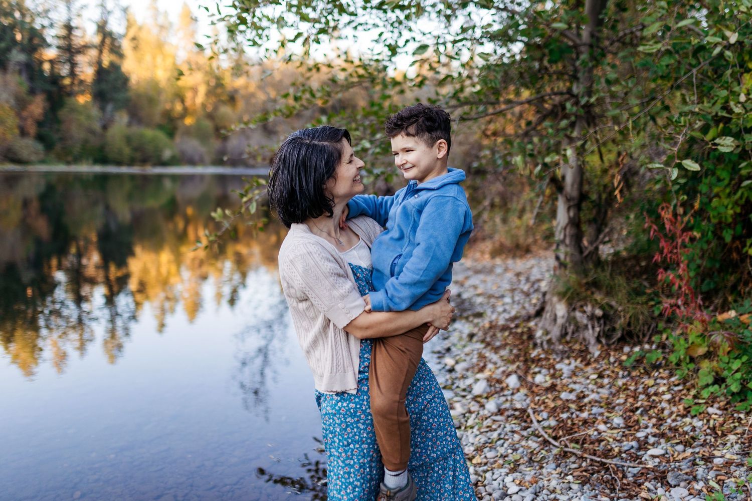 mom and son laugh together by the rogue river