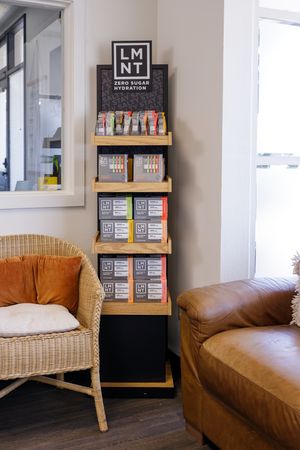 buoyant chiropractic woman practitioner in Tacoma, WA personal branding product photo of LMNT product stand in sitting waiting lobby room
