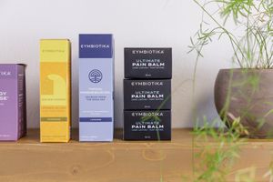 buoyant chiropractic woman practitioner in Tacoma, WA personal branding product photo of pain balm on shelf