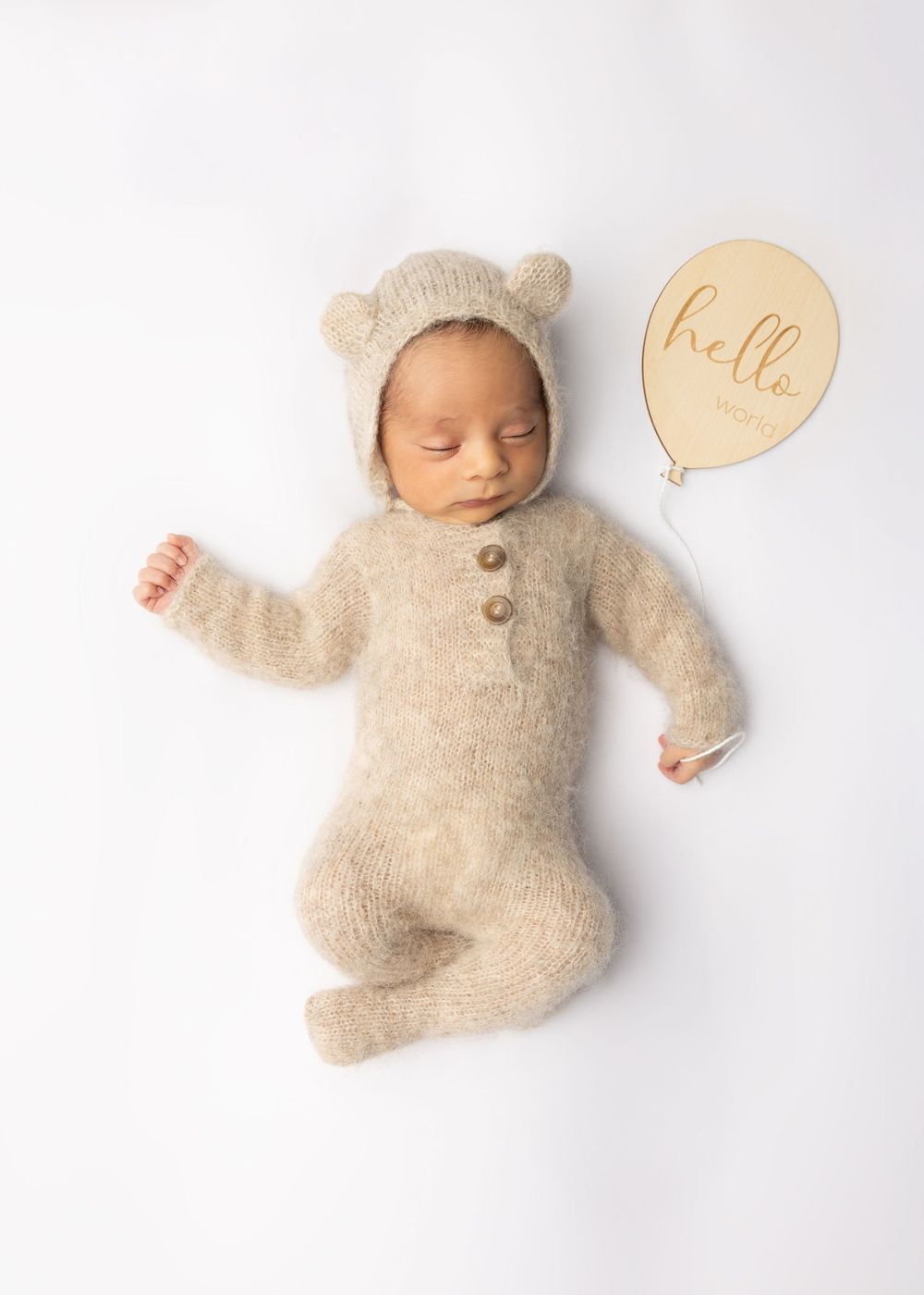 A trio of cream-colored stuffed plush animal toys arranged in different poses against a white background.