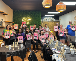 Large group displaying their completed pet portrait paintings at an art studio event.