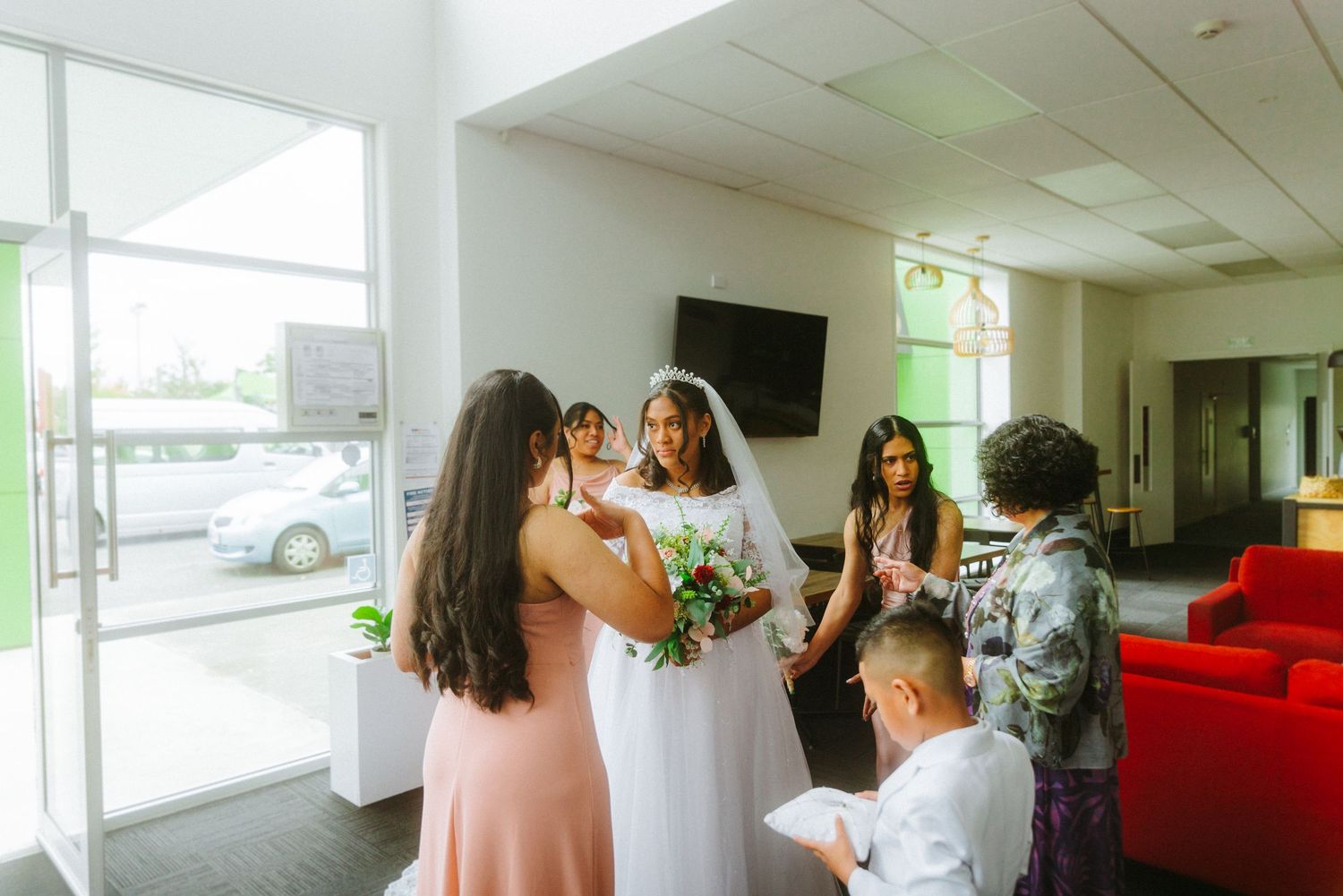 bride smiling and looking into the grooms eyes, they are dressed in wedding garments, wedding dress in the foreground.