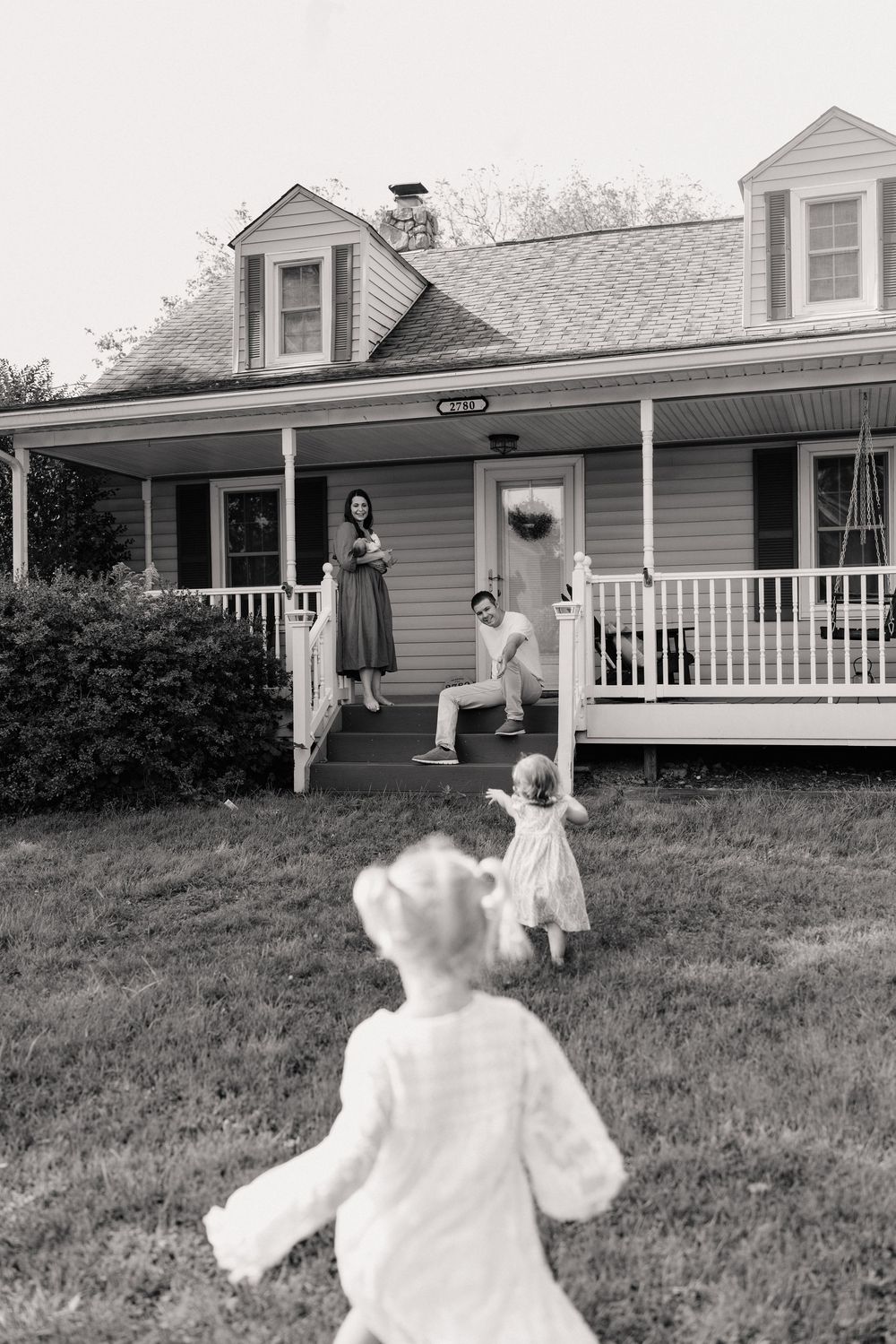 A series of black and white photos showing two figures in a backyard with one wearing a flowing white dress in Adamstown Maryland.