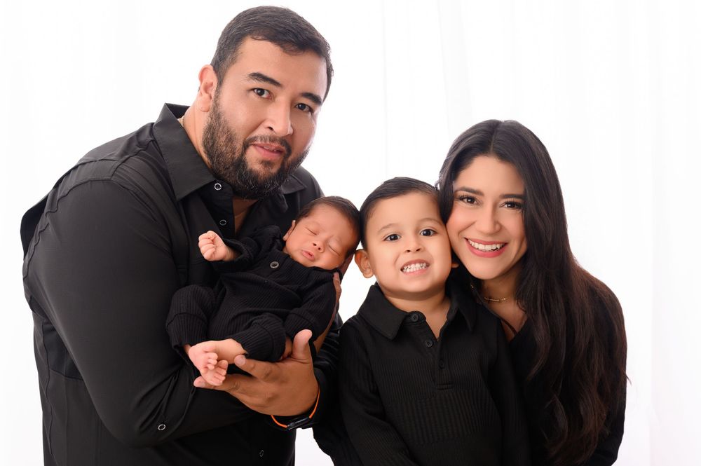 Family photo collection showing candid moments in coordinated black and white outfits.
