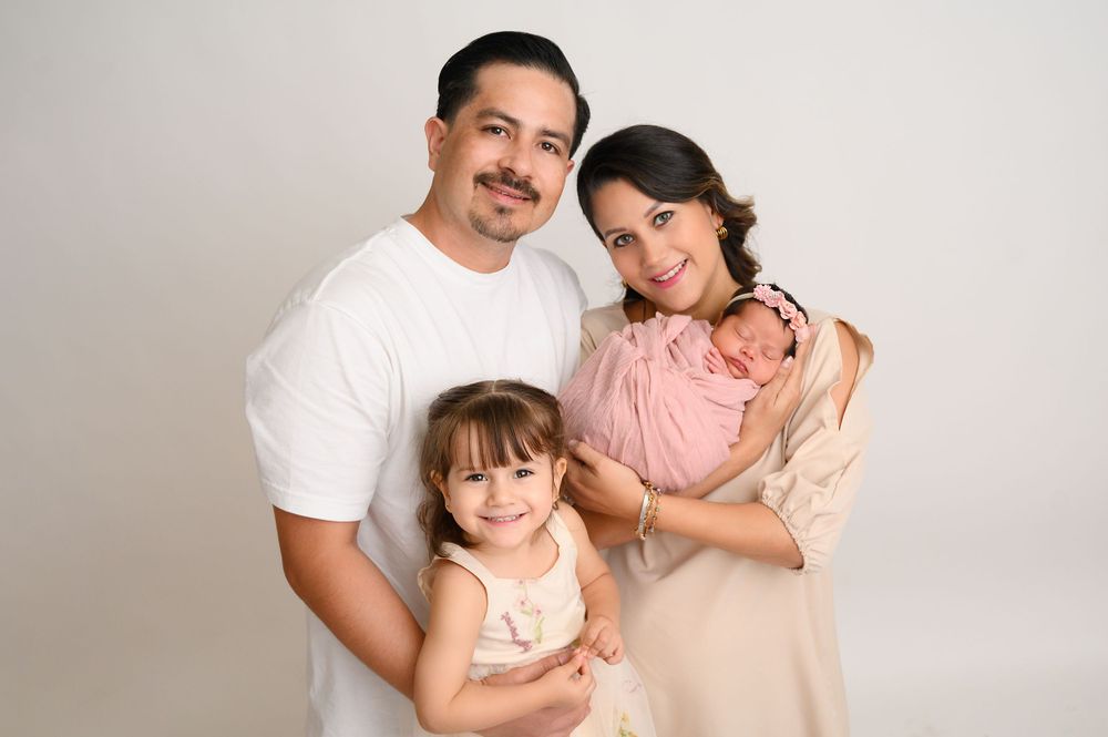 Sweet family moments captured in professional studio photos with neutral backdrop.