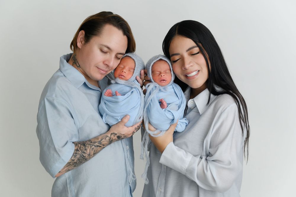 Family portrait series in matching gray outfits showing tender moments against white backdrop.