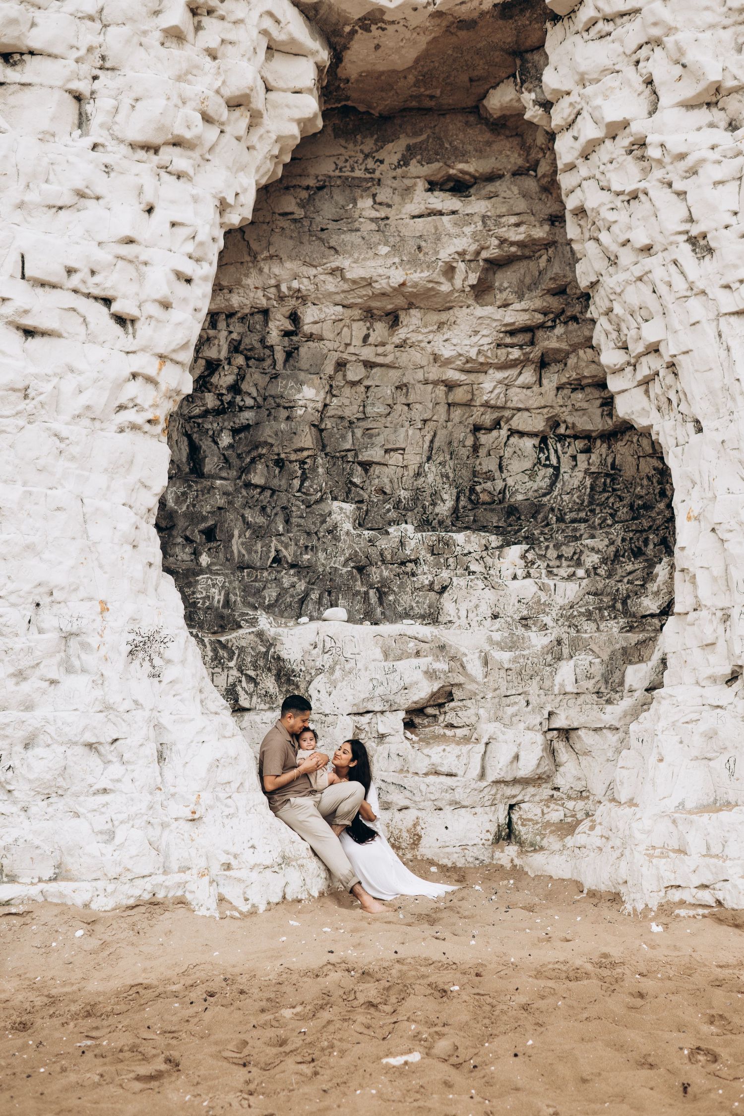 a family sitting on the beach during a photo session with Forever  Ours Photography in Botany Bay, Kent, UK