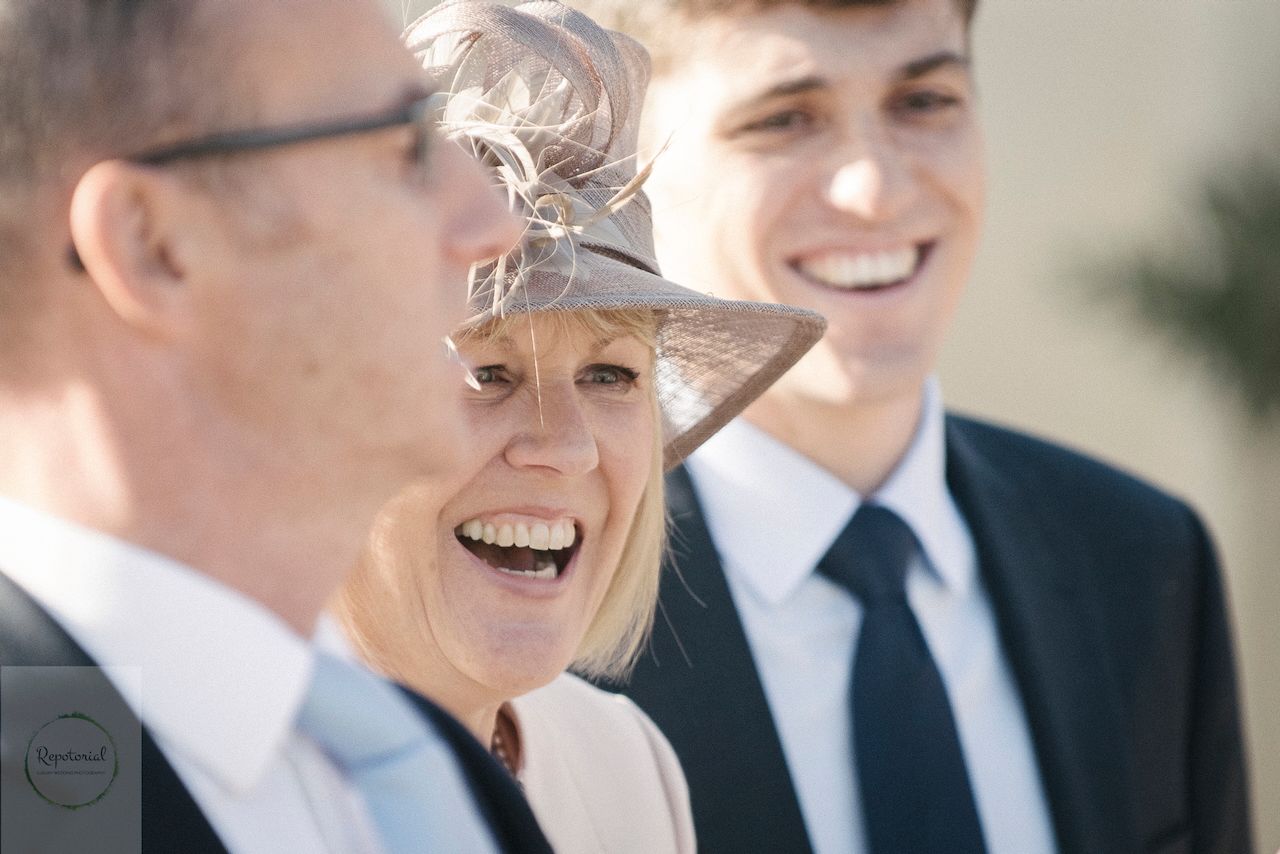 Guests enjoying the wedding reception captured in candid style. Stratton Court Barn