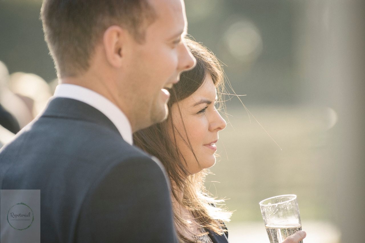 Guests enjoying the wedding reception captured in candid style. Stratton Court Barn